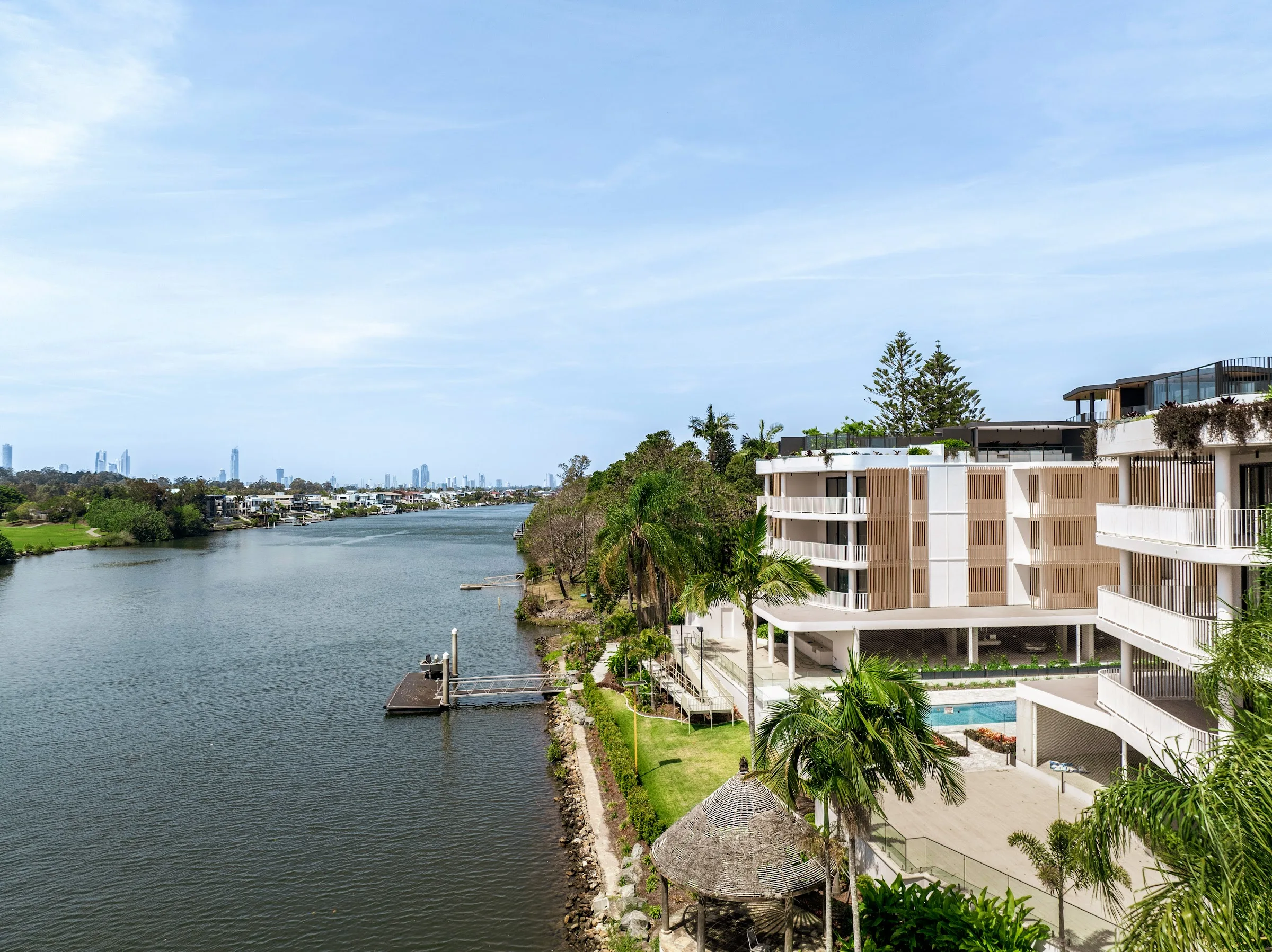 Landscaped river edge with pool and gardens
