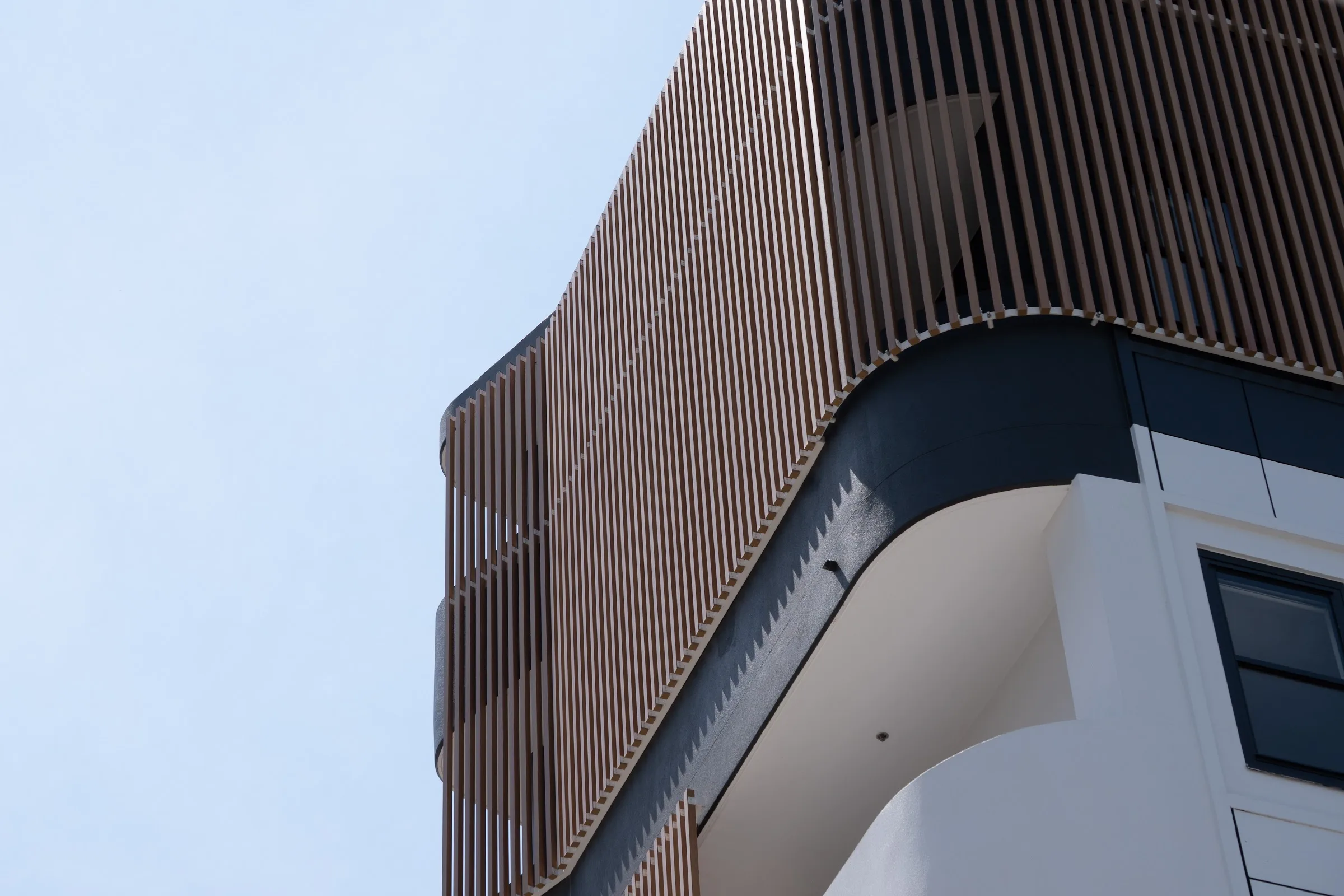 Timber-look battens wrapping the curve