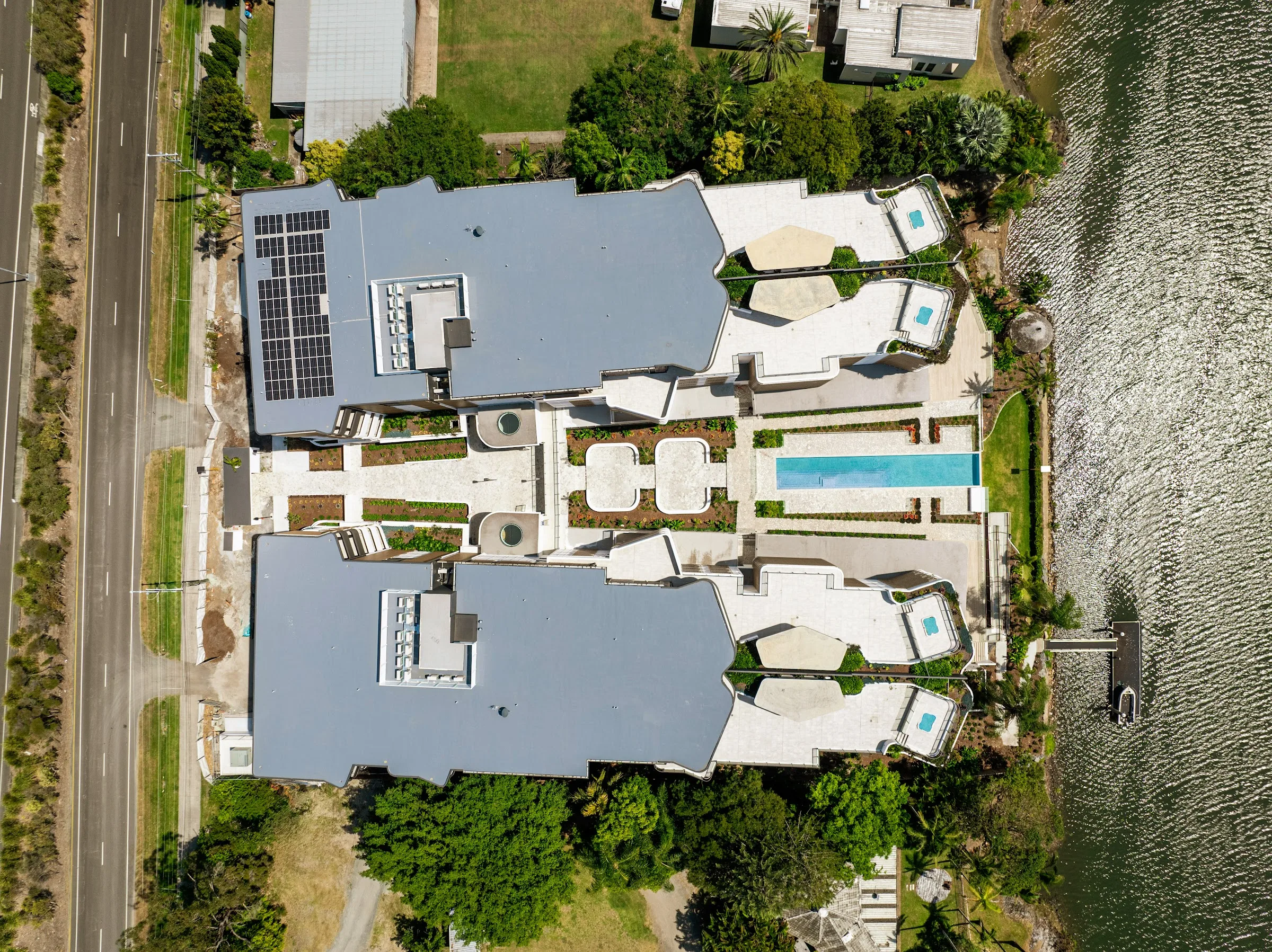 The two buildings angled to the Nerang River